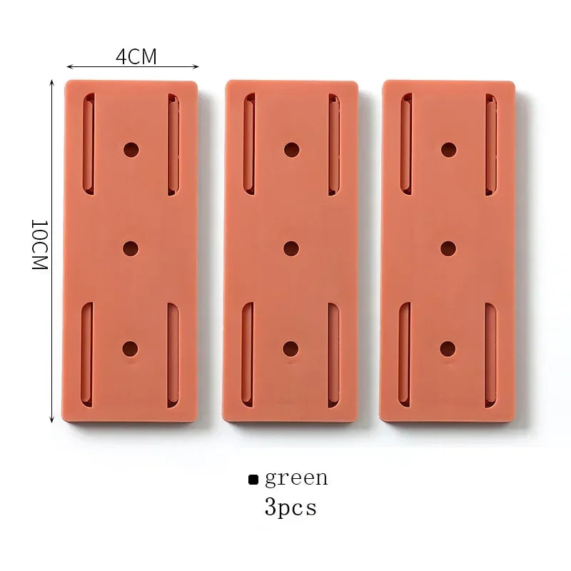 Trois plaques rectangulaires en silicone orange de 10x4 cm avec perforations et fentes