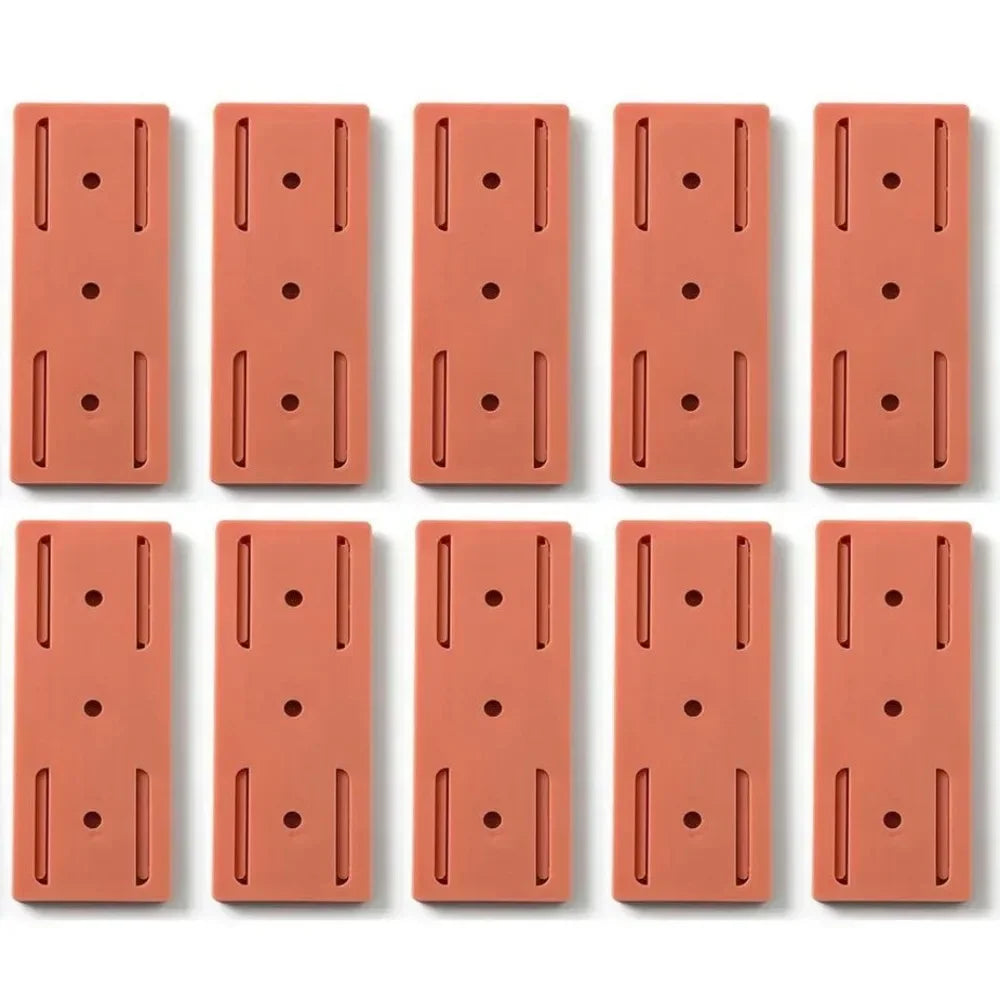 Douze plaques rectangulaires rouges en silicone avec trous et rainures, sur fond blanc